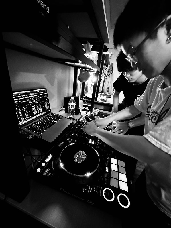 Two friends DJing together